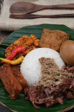 Nasi Gudeg Krecek, işlenmiş taze kaya meyvesi, hindistan cevizi sütü, baharat, tofu, yumurta ve tavuktan yapılan pirinç ve rehberdir. Yogyakarta spesyalleri. Endonezya yemeği. Muz yapraklarıyla servis edilir..