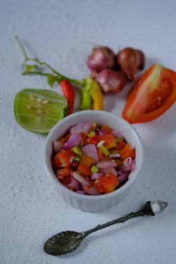 Sambal Dabu-dabu, Kuzey Sulawesi veya Manado şehrinde bulunan taze domates, kırmızı biber, dilimlenmiş arpacık soğanı, limon suyu, tuz ve yağdan yapılan tipik bir biber sosudur. Endonezya yemekleri.