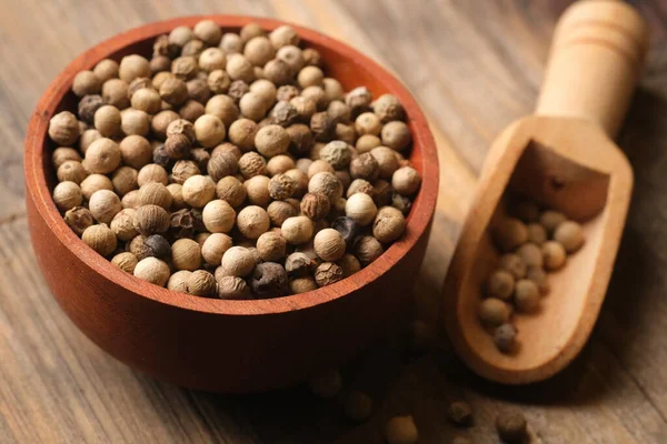 stock image white pepper in the wooden bowl. pepper is a flowering vine in the family Piperaceae, cultivated for its fruit, which is usually dried and used as a spice and seasoning. Piper nigrum.