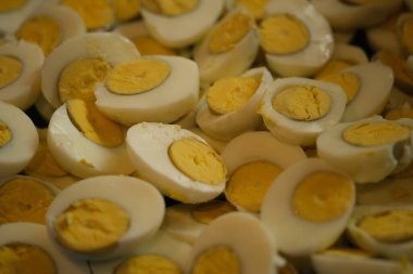 Closeup of a halved boiled eggs. source of animal protein. allergens. cause allergies. telur rebus.