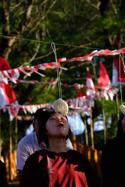 stock image Yogya, Indonesia. August 13, 2023. Lomba Makan Kerupuk is the cracker eating contest, is a competition held in commemoration of the Independence Day of the Republic of Indonesia. Indonesia merdeka.