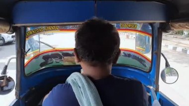 Jakarta 'da bir bajaj' a binmek. Bir bajaj içerisinden görüntüle.