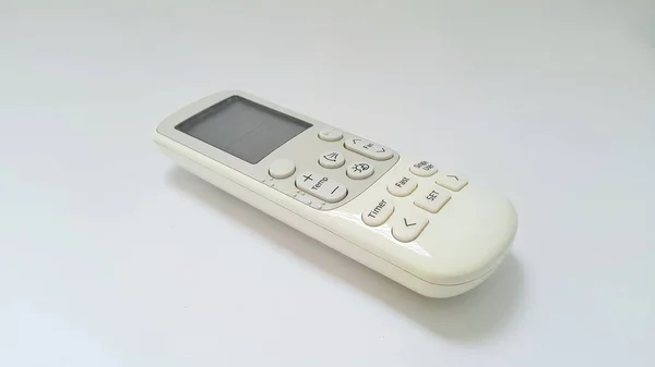 Close up of air conditioner remote control with display on white background