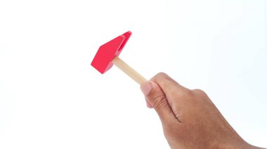 Hand holding wooden hammer on white background