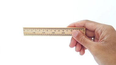 Hand holding wooden ruler isolated on white background