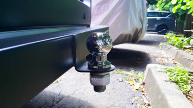 Tow bar and tow ball on a car. Outdoors.