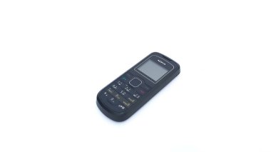 Close up of Nokia cellphone isolated on white background. Nokia 1202 series. The old type. Jakarta, Indonesia - January 19, 2023.