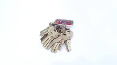 Bunch of keys on key ring arrangement isolated on white background