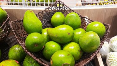 Pile of avocado fruits in the basket at a supermarket