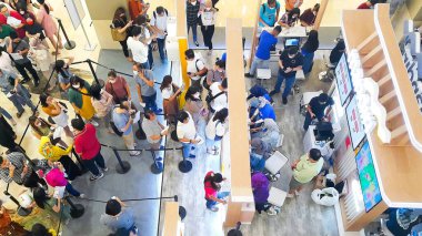 Top view of queue of people at an exhibition in a shopping mall (Jakarta, Indonesia - February 04, 2023)