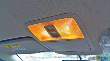 Close up interior view of the car roof or ceiling light panel. Car cabin lights that turn on when the door is open.