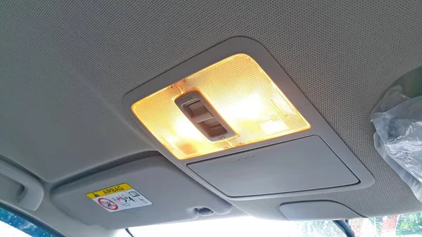 Close up interior view of the car roof or ceiling light panel. Car cabin lights that turn on when the door is open.