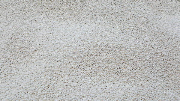 Polypropylene granule close-up background texture. plastic resin ( Masterbatch).Grey chemical granules for industrial plastic production.