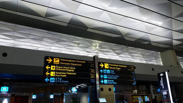 stock image Interior and Signboard of an Airport in multiple languages.