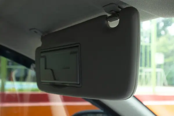 Car sun visor in the down position. Car interior.