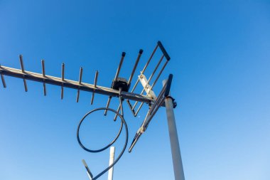 Aerial TV Antenna with clear blue sky clipart