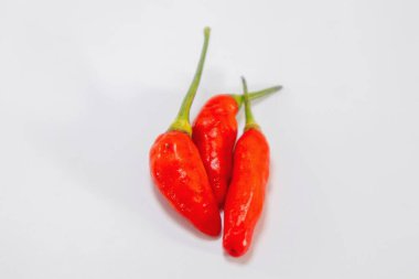 Üç kırmızı arnavut biberi ya da koyu arkaplanda çok baharatlı tadı olan Capsicum frutesans