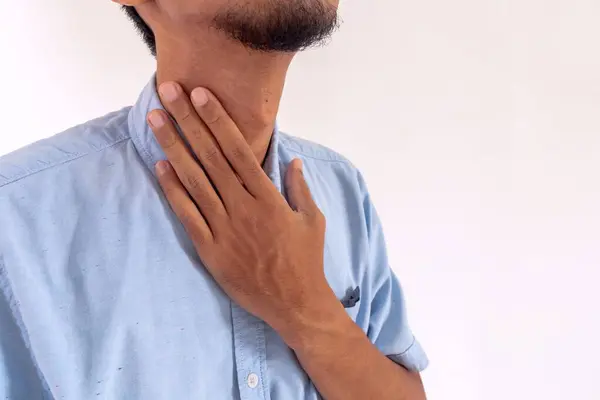 stock image Man has sore throat and touches his throat