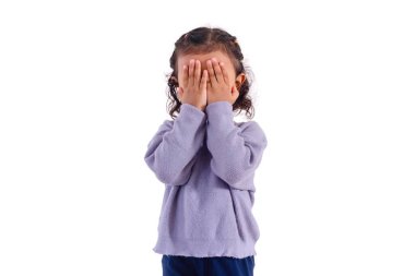 A little Asian girl covering her face with both hands, on a white background