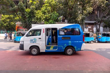 Jakarta, Indonesia - August 10, 2024: A public minibus or public transportation car on the street in Jakarta clipart