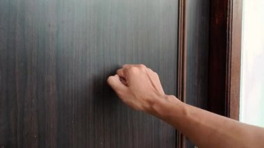 Erkek el kapıya vuruyor. Görüntüyü kapat.
