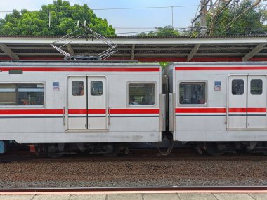 Jakarta, Indonesia - November 10, 2024: Side view of a commuter train carriage stopped at a station in Jakarta clipart