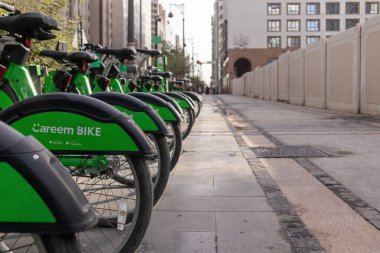 Madinah, Saudi Arabia - December 18, 2024: One of Careem bike station in the city of Medina. A station to rent bicycles using an app on a smartphone. clipart