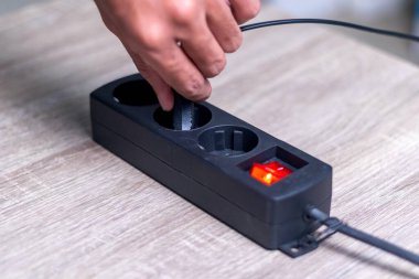 El çekme ya da prizi elektrik uzatma kablosunun prizine yerleştirme