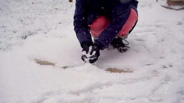 Girl Makes Snow Her Hands Play Snowballs — Video Stock