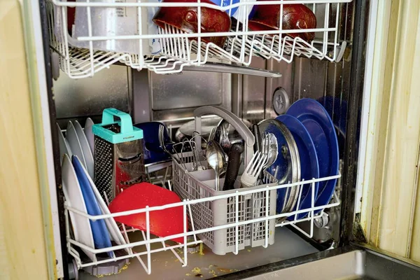 Clean dishes in the dishwasher after washing