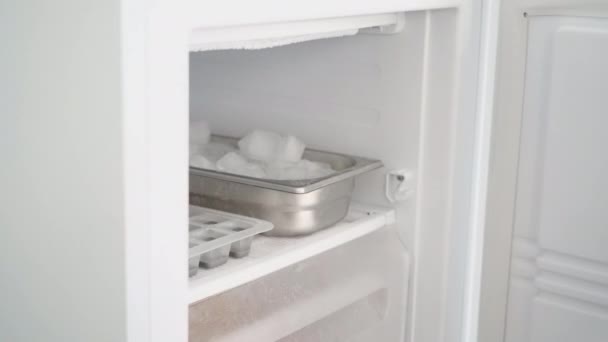 Girl Takes Ice Cubes Freezer Puts Them Glass Cold Drink — Stockvideo