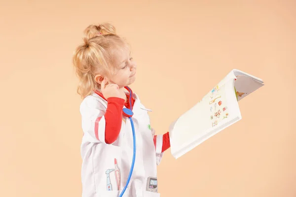 Holčička Stetoskopem Drží Rukou Knihu Dívá — Stock fotografie
