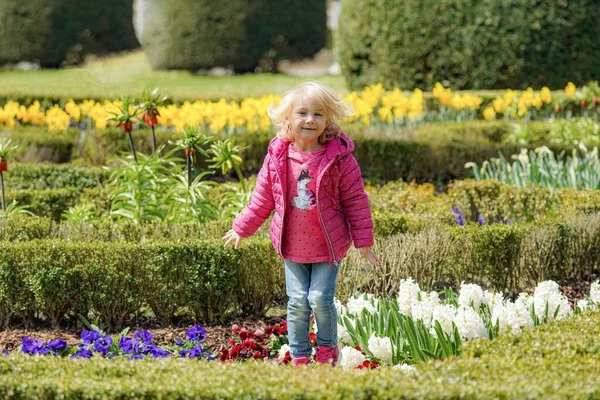 Petite Fille Joyeuse Saute Pose Parmi Belles Fleurs Dans Parc — Photo