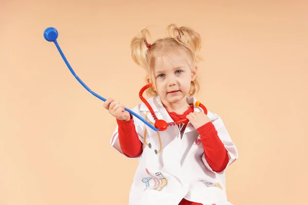 一个带听诊器的小女孩扮演医生 — 图库照片