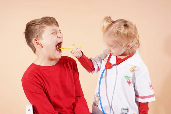 stock image A child dentist and a joyful patient check their teeth at a doctors appointment. private treatment concept. High quality photo