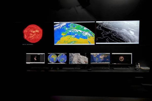 Monitors with space photos at the mission control station. High quality photo