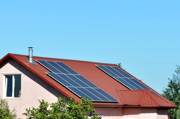 Solar panels on the roof of a country house, environmental production of solar energy in electrical.