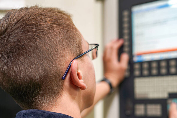 The CNC milling machine programmer makes adjustments to the program to change the cutting parameters.