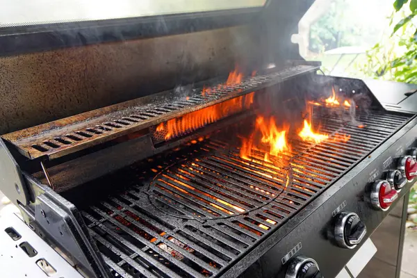 The fire heats up the grate on a gas grill for grilling meat.
