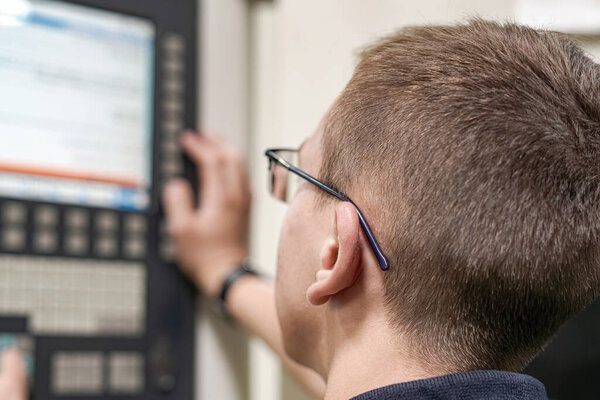 The CNC milling machine programmer makes adjustments to the program to change the cutting parameters.