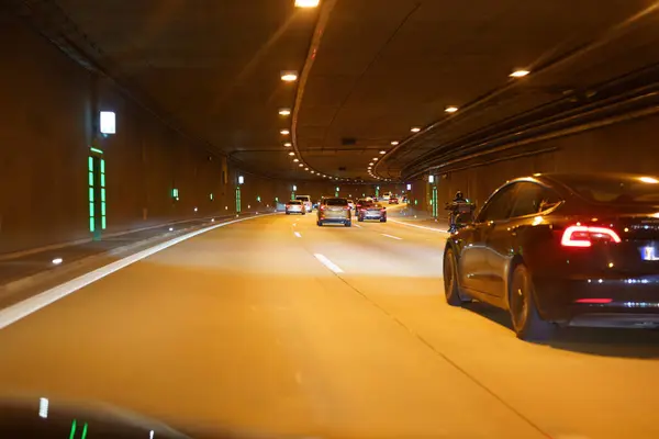 stock image Tunnel on a road with cars and night lighting.