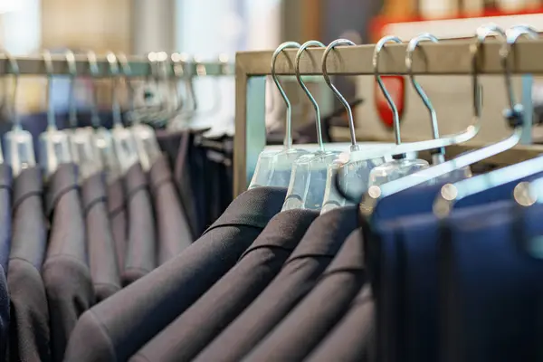 Men\'s suits in the store for sale.