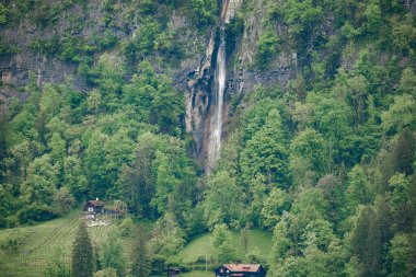 Meltwater flows down from the peaks of the Alps in Switzerland. clipart