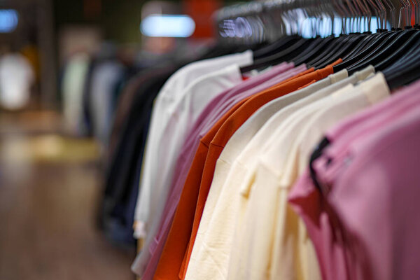 Women's clothing on display in a clothing store in a shopping mall.