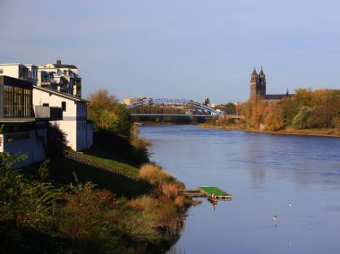 View on Elbe river in Magdeburg, the Sternbrucke and the Cathedral of Magdeburg can be seen.