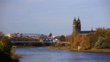 View on Elbe river in Magdeburg, the Sternbrucke and the Cathedral of Magdeburg can be seen.