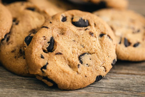 Cookies with chocolate crisps on a wooden background, close-up.