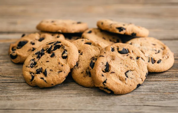 Cookies with chocolate crisps on a rustic wooden background, close-up.