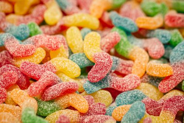 Candy background, chewing jelly candies in the form of worms, close-up.