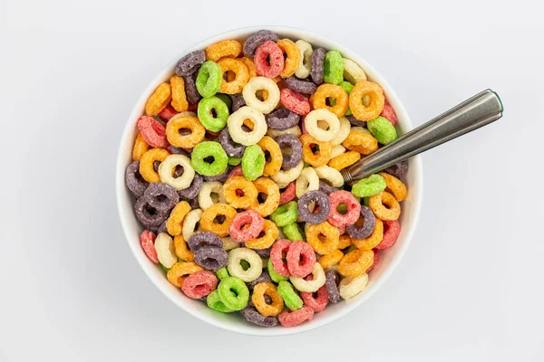 Colored breakfast cereal in a bowl on a white background, flat lay, childrens healthy breakfast, close up.